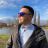 Sergiu Vlad outdoors by a lake, wearing sunglasses